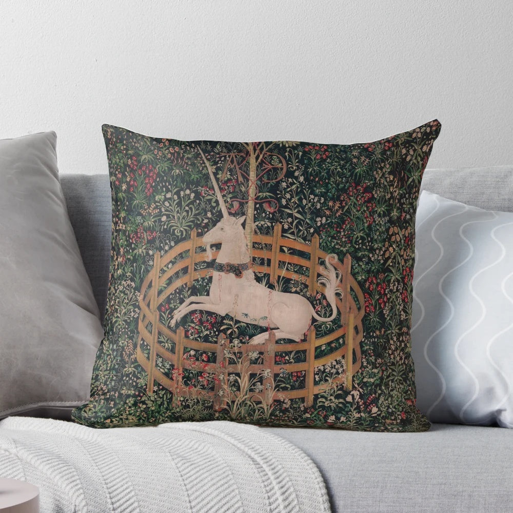 A decorative throw pillow featuring a magical unicorn in a medieval, renaissance-style floral landscape.
