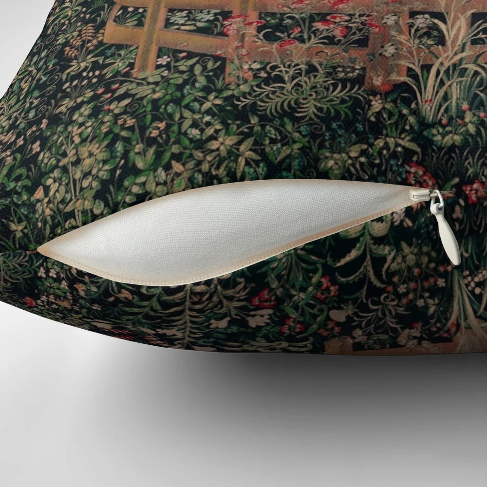 A decorative throw pillow featuring a magical unicorn in a medieval, renaissance-style floral landscape.