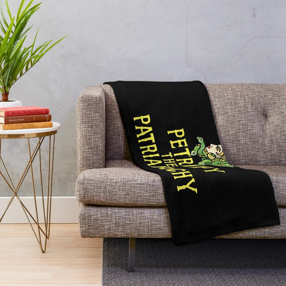 Plush blanket with a Medusa-inspired feminist design, encouraging people to "Petrify the Patriarchy