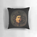 A decorative pillow featuring the iconic image of Medusa's head, inspired by the renowned Baroque painting by Caravaggio.