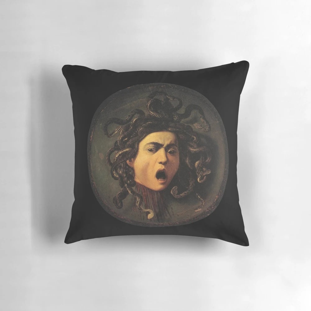 A decorative pillow featuring the iconic image of Medusa's head, inspired by the renowned Baroque painting by Caravaggio.