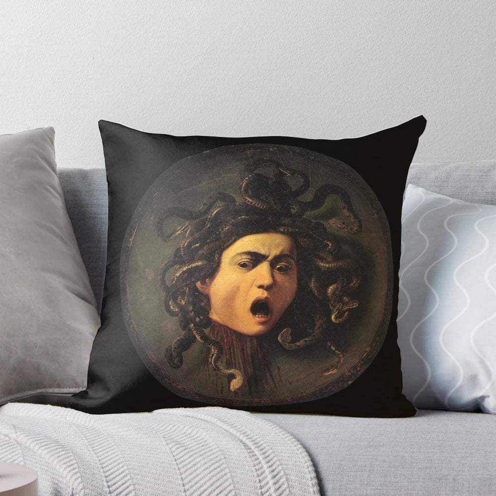 A decorative pillow featuring the iconic image of Medusa's head, inspired by the renowned Baroque painting by Caravaggio.