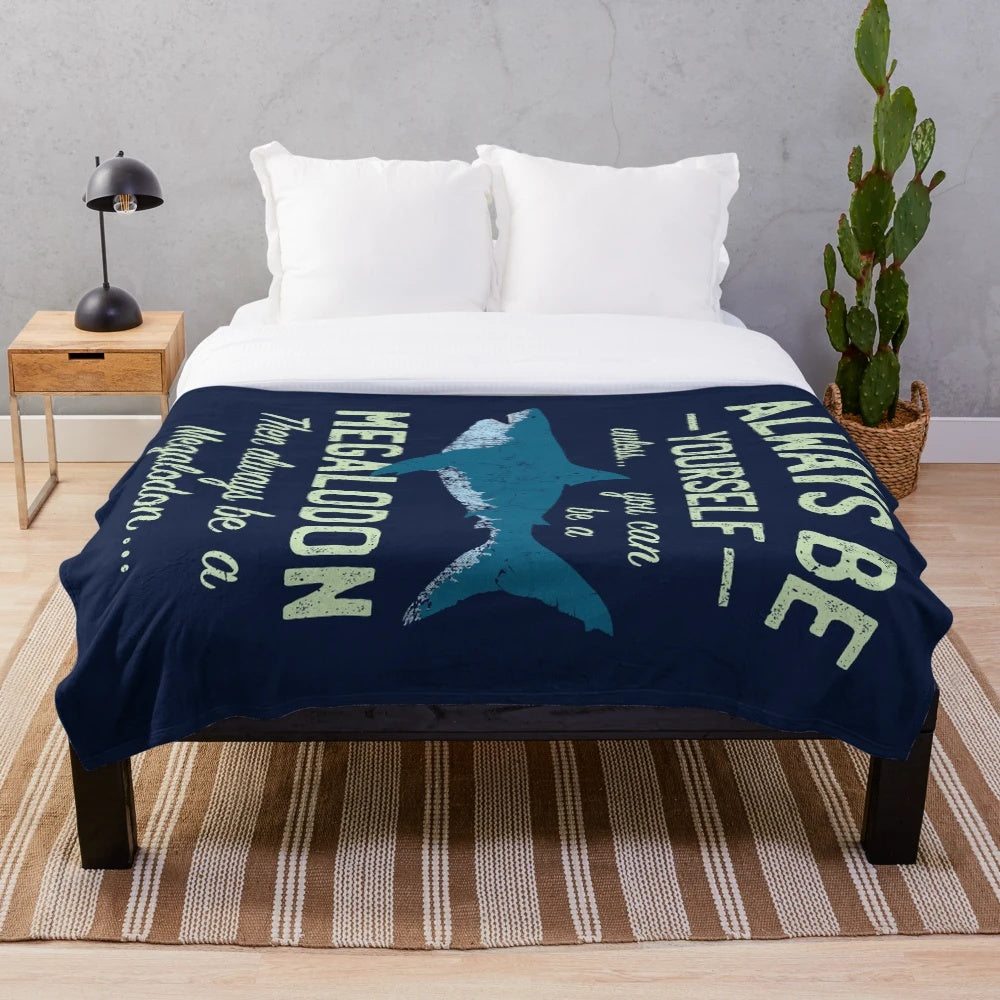 Megalodon themed plush blanket with shark teeth design