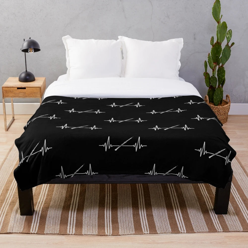 Plush blanket with oboe and music heartbeat design