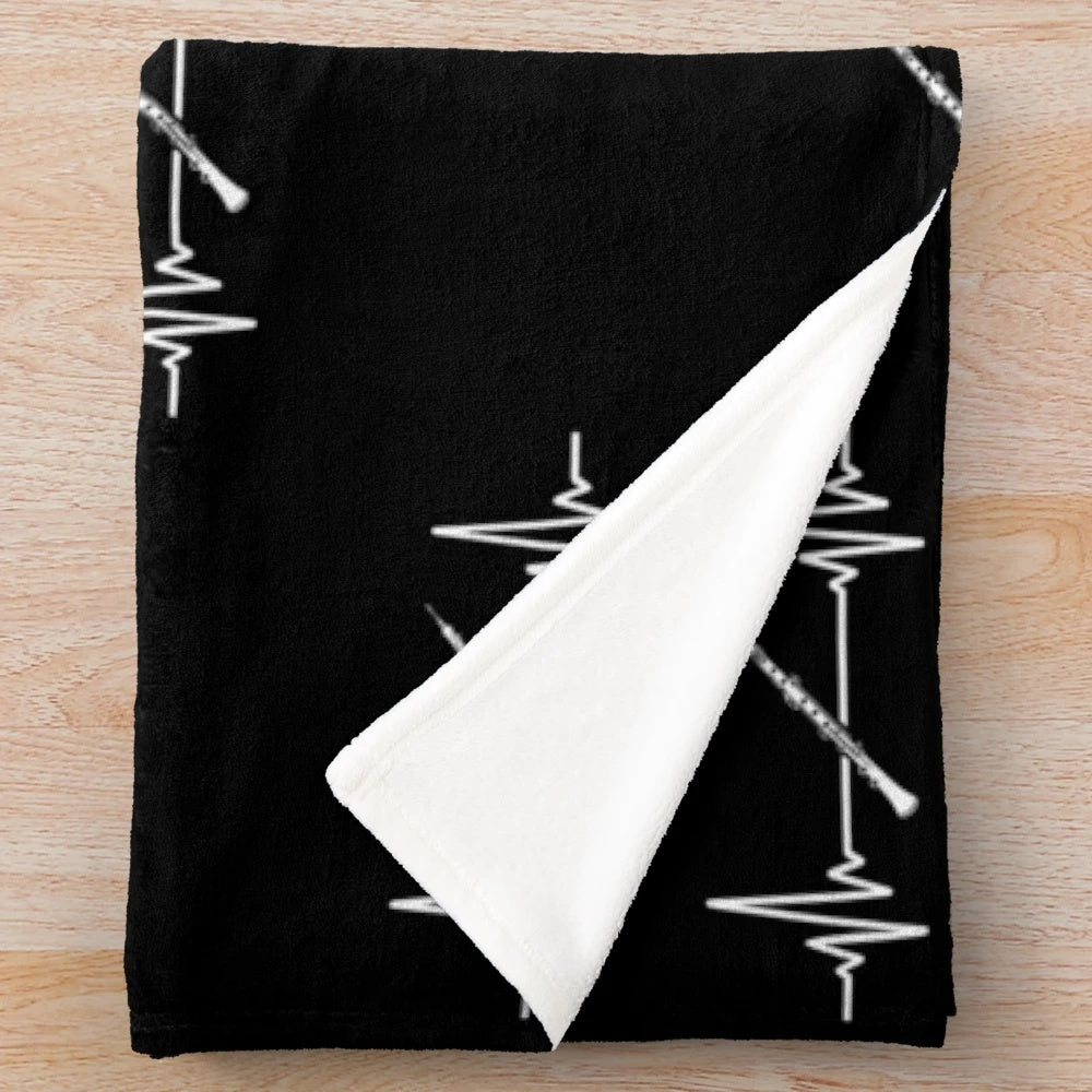 Plush blanket with oboe and music heartbeat design