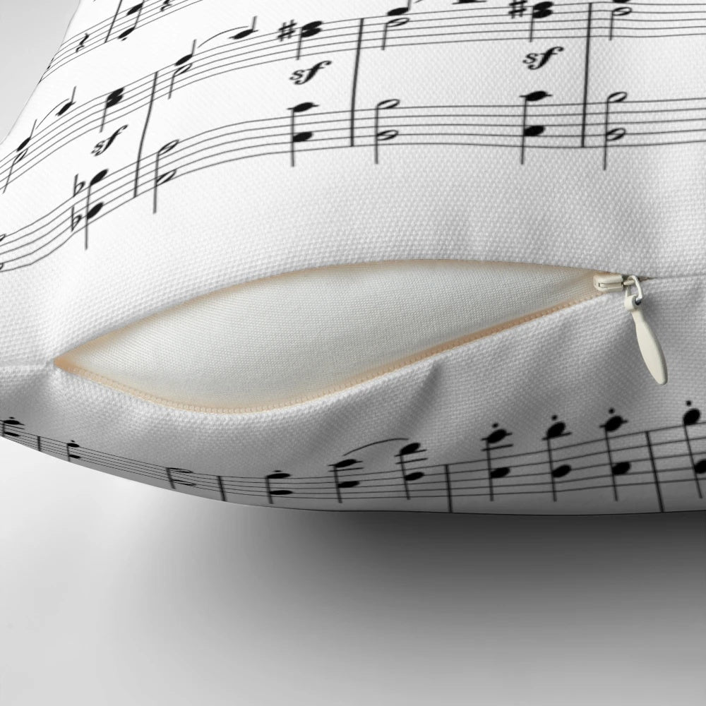 A plush, decorative pillow featuring a vibrant design of musical notes and sheet music, perfect for music enthusiasts.