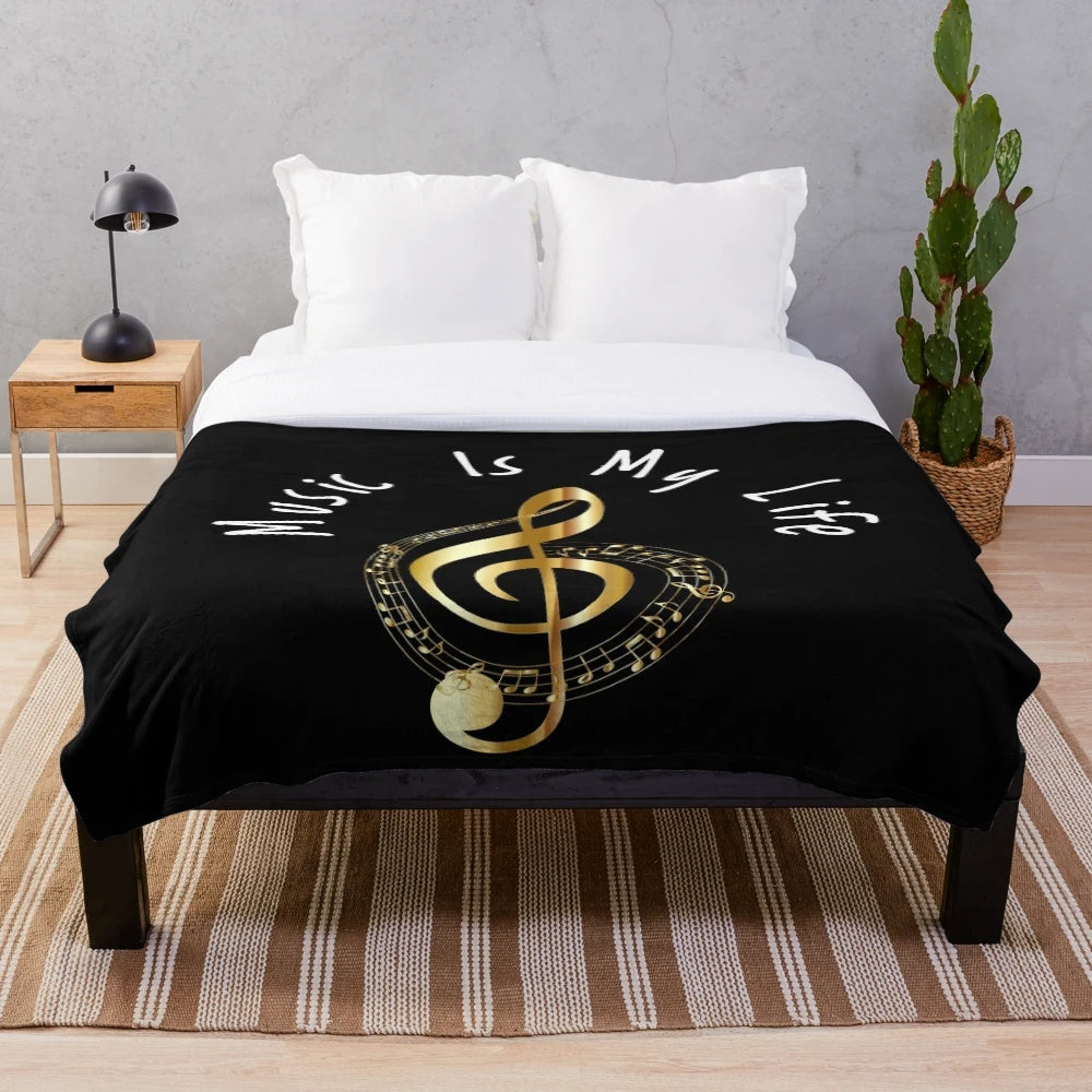 Plush blanket featuring a golden treble clef design, perfect for music lovers.