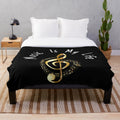 Plush blanket featuring a golden treble clef design, perfect for music lovers.
