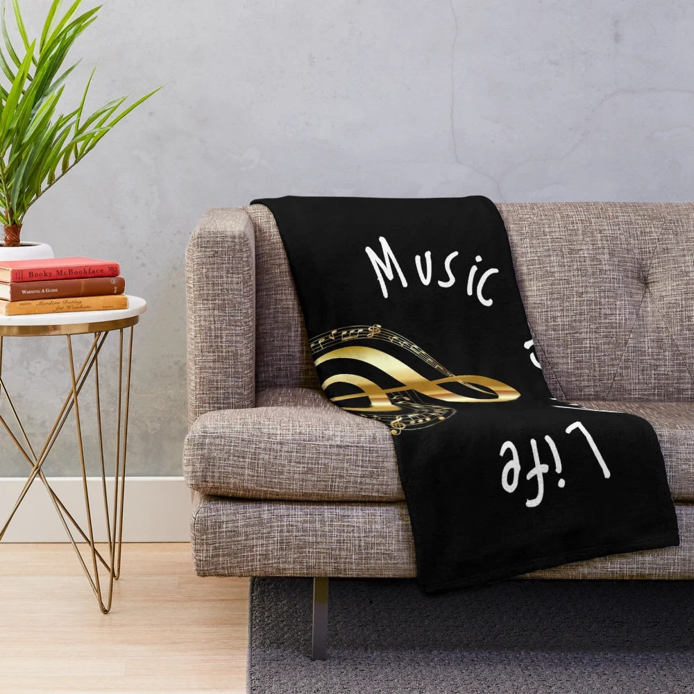 Plush blanket featuring a golden treble clef design, perfect for music lovers.