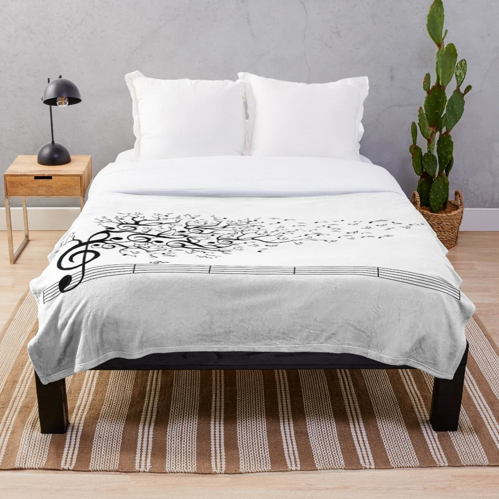 Plush blanket with nature-inspired design and calming musical elements