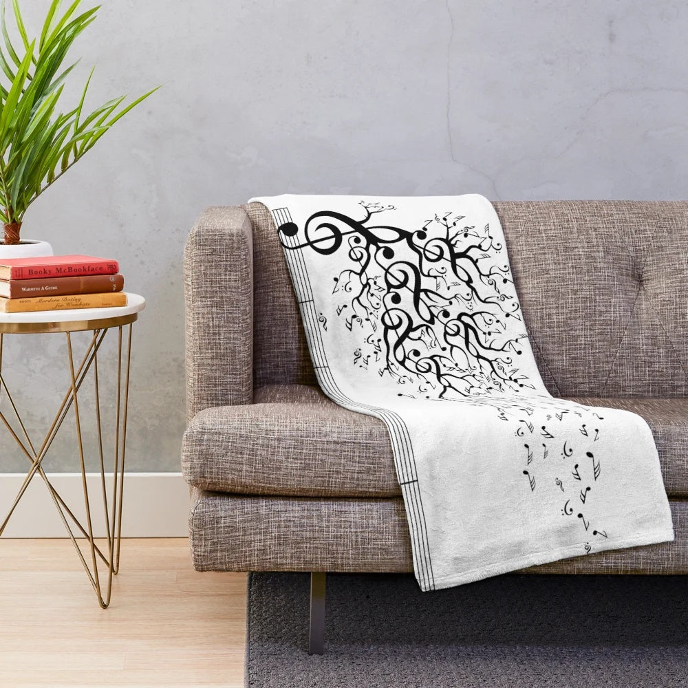 Plush blanket with nature-inspired design and calming musical elements