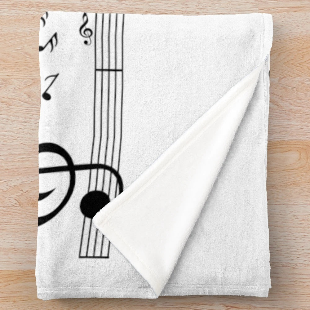 Plush blanket with nature-inspired design and calming musical elements