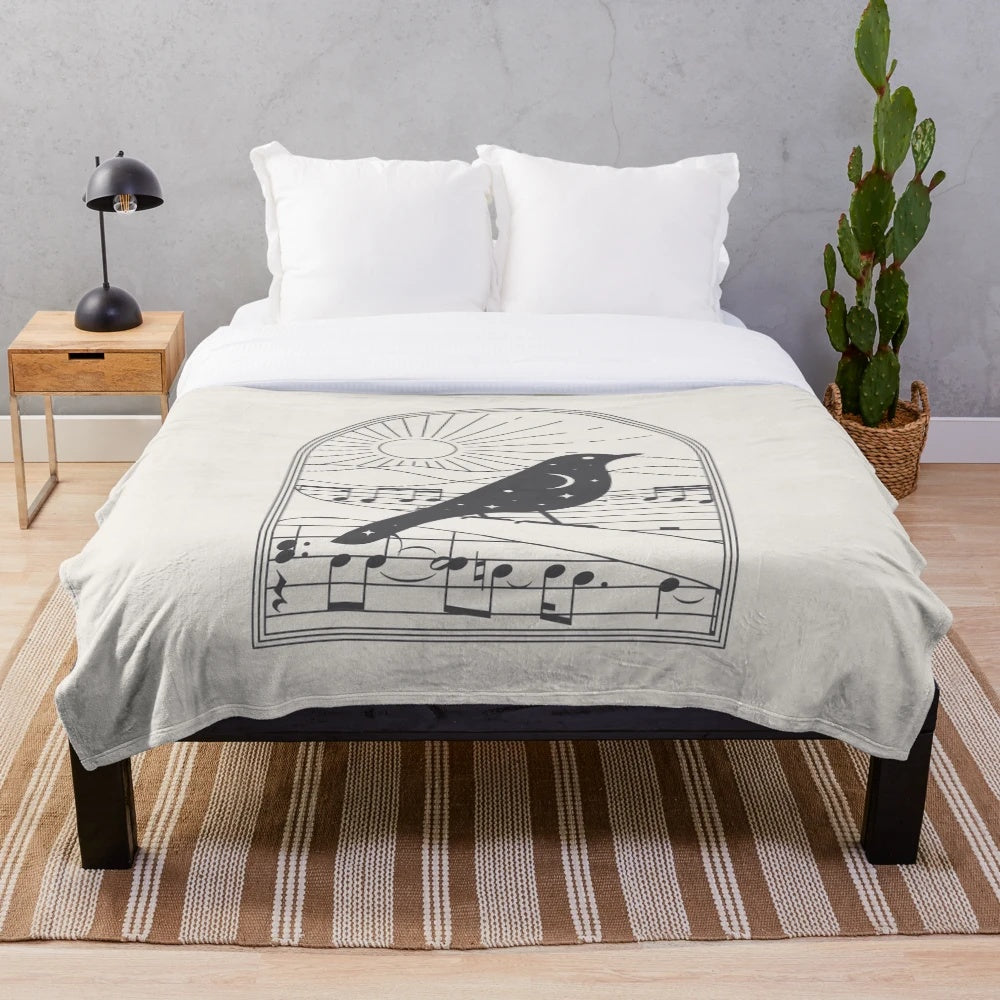 Plush black and white blanket with bird and music note design