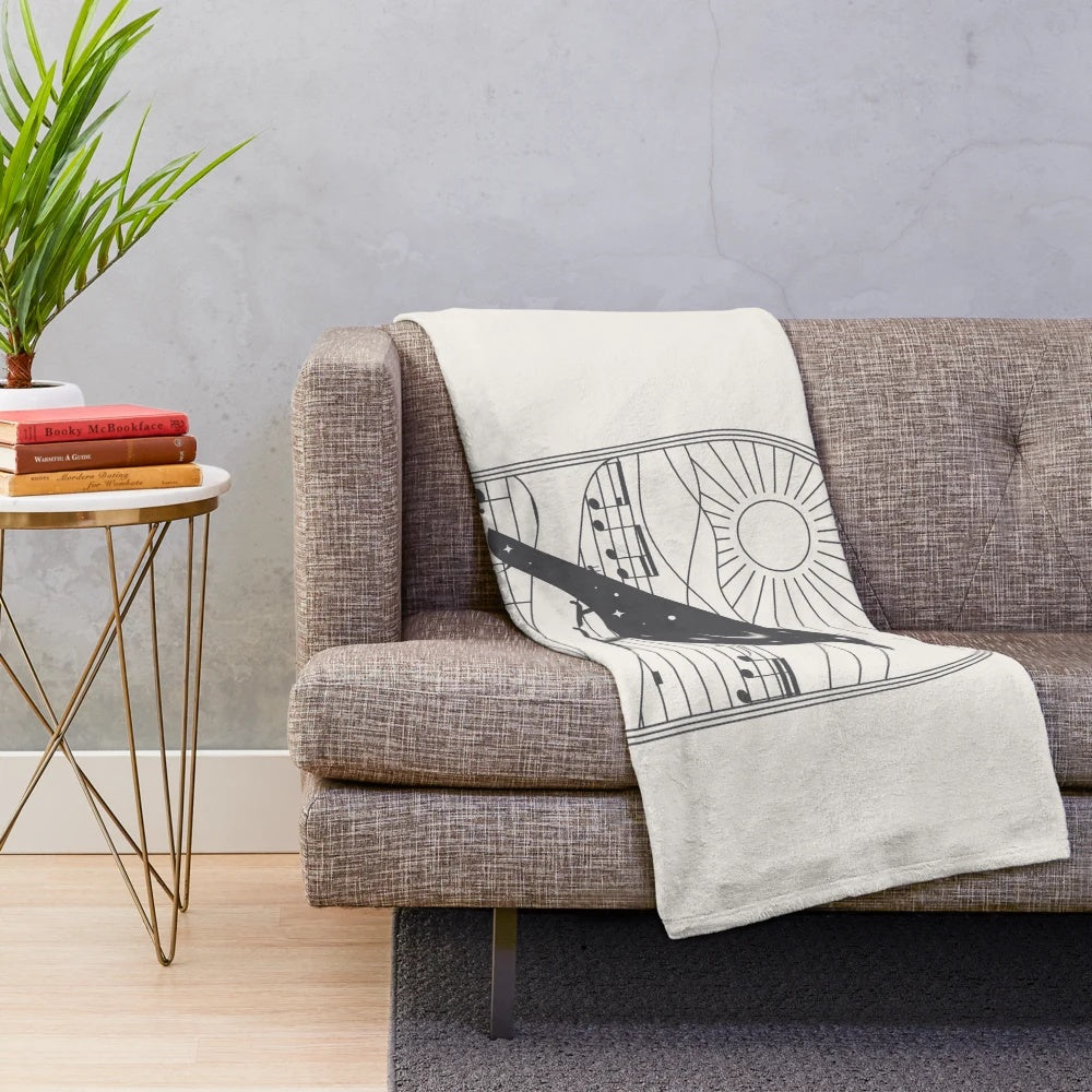Plush black and white blanket with bird and music note design