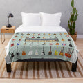 A plush blanket featuring various types of guitars, perfect for music lovers.