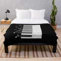 Plush blanket featuring piano keys and music notes design, perfect for music lovers