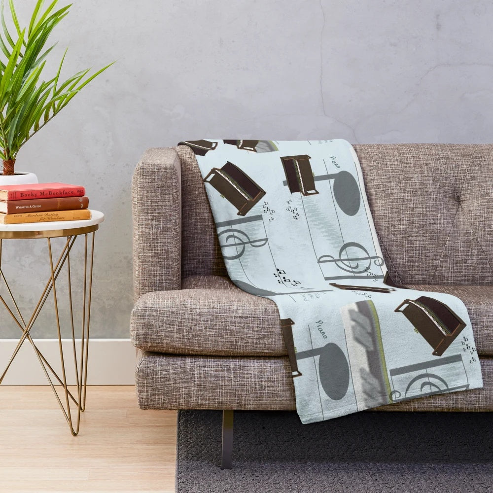 A plush blanket featuring a musical motif of piano keys and treble clef
