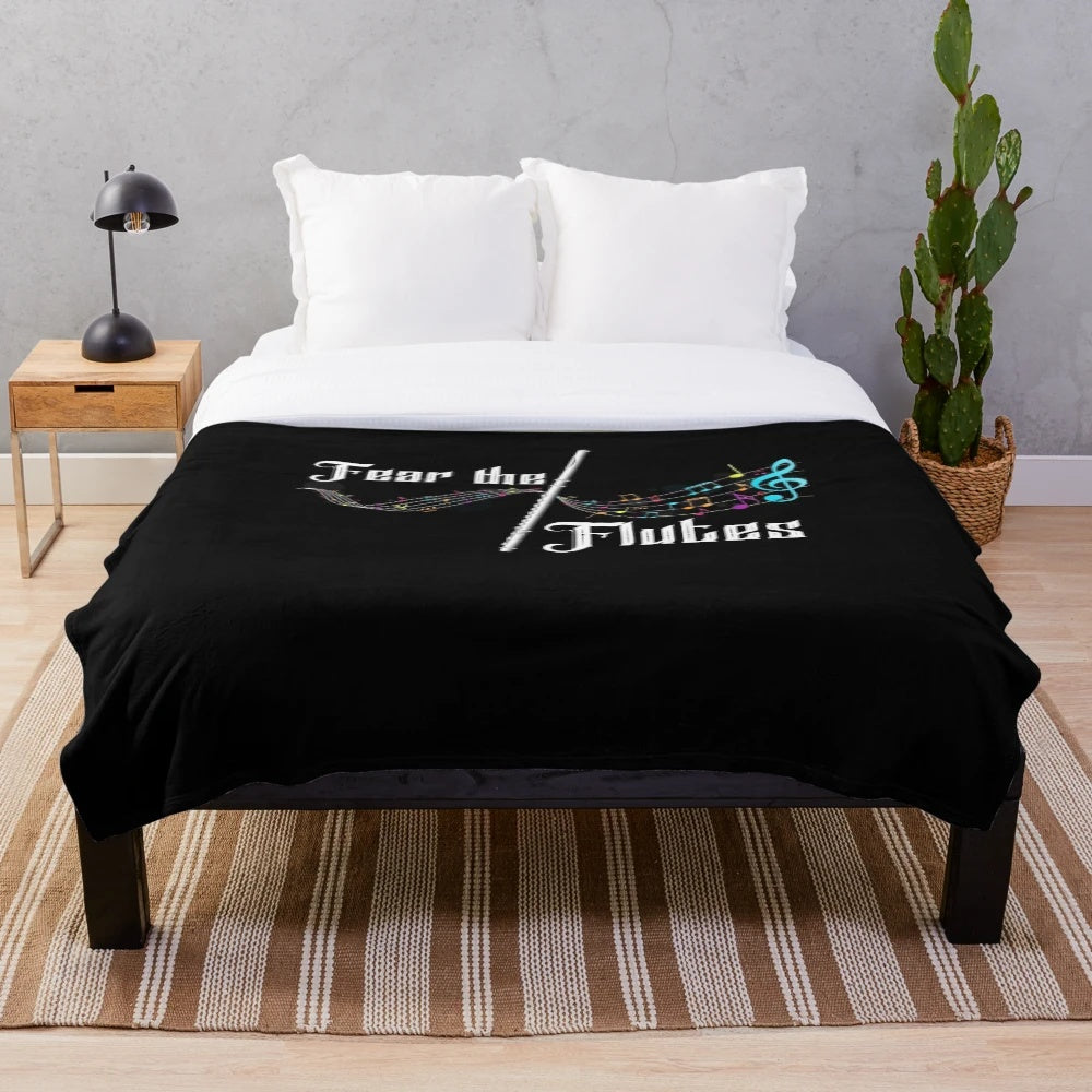 Plush blanket featuring a musical flute design