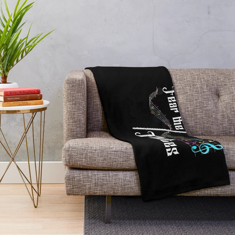 Plush blanket featuring a musical flute design