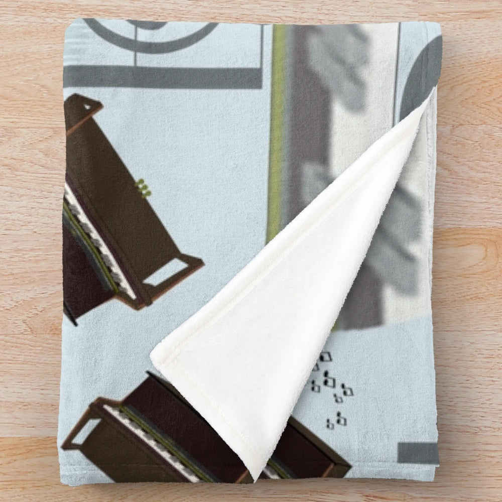 A plush blanket featuring a musical motif of piano keys and treble clef