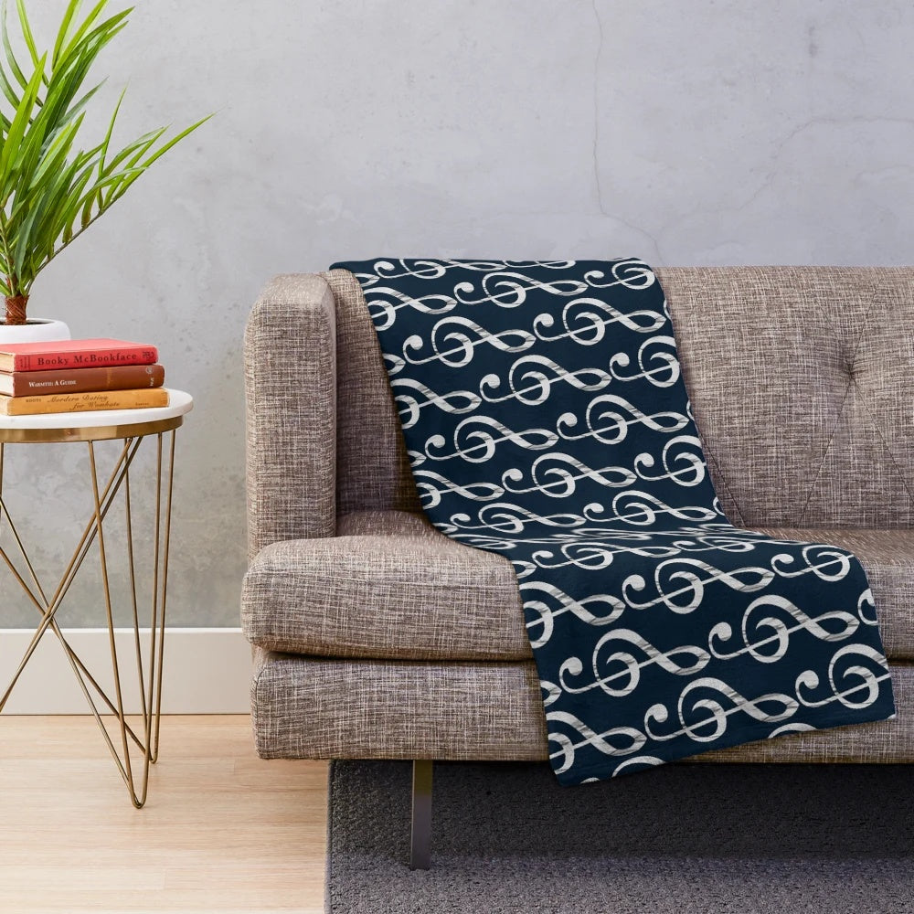Treble clef plush blanket with a musical design