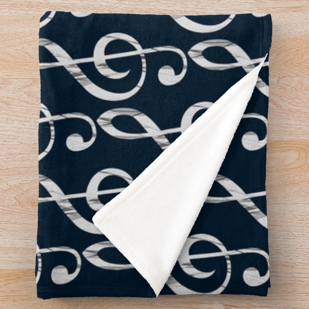 Treble clef plush blanket with a musical design