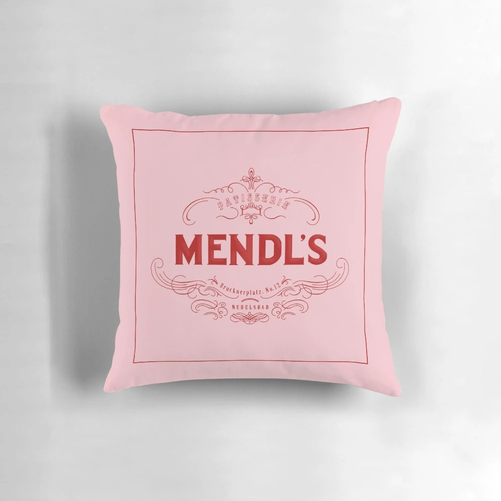 Mendl's Pillow, a decorative pillow inspired by the iconic patisserie from the Wes Anderson film The Grand Budapest Hotel.