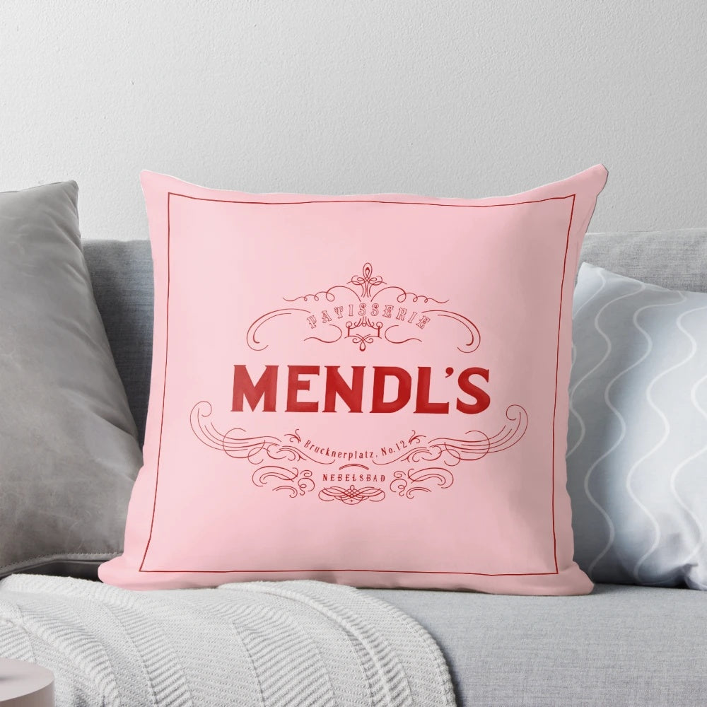 Mendl's Pillow, a decorative pillow inspired by the iconic patisserie from the Wes Anderson film The Grand Budapest Hotel.