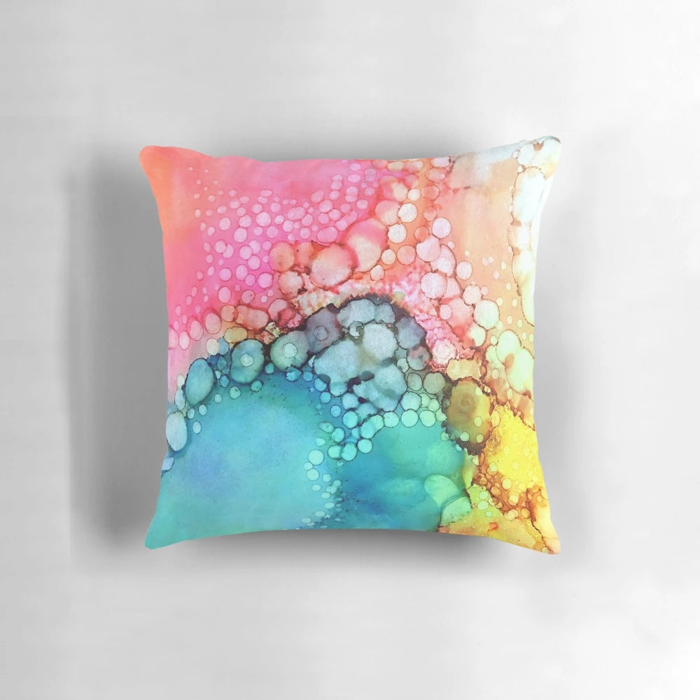 Vibrant and fluid abstract art design featuring colorful bubbles and dynamic movement on a plush pillow