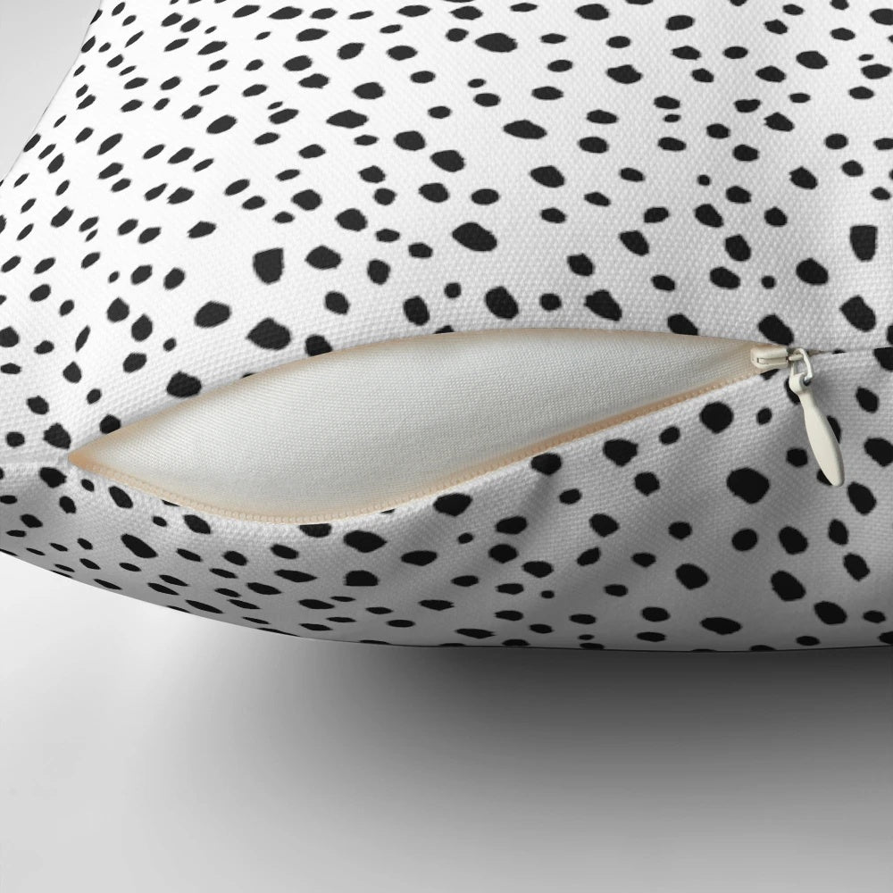 Decorative black and white polka dot pillow