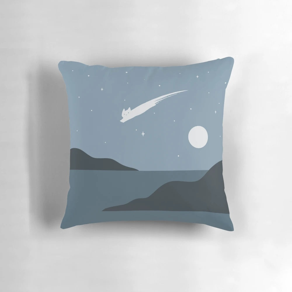 A cozy, minimal cat landscape pillow with a night sky, stars, and a meteor shower design.