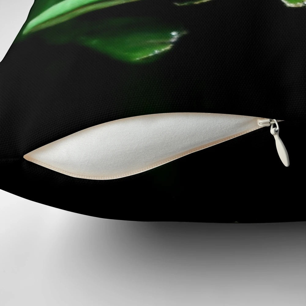Detailed image of a realistic green frog face on a plush pillow, perfect for adding a touch of the tropics to your home.