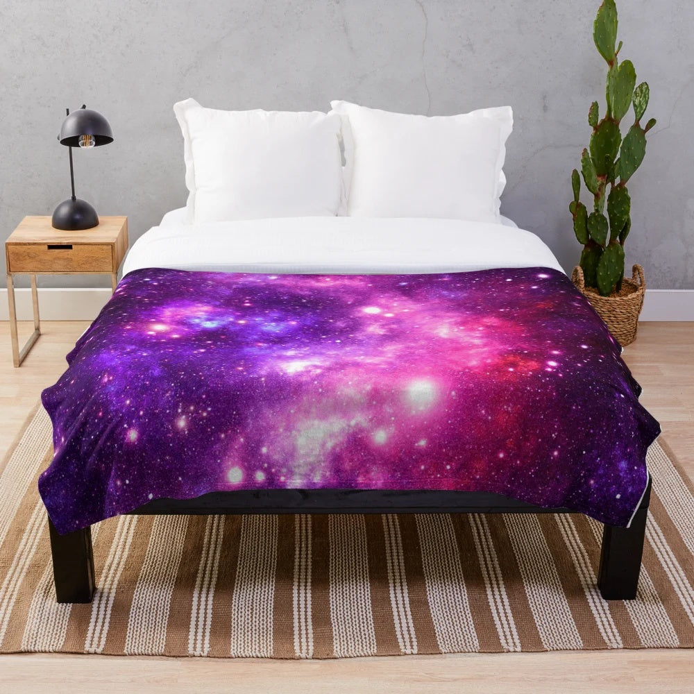 Soft and cozy pink and purple galaxy nebula plush blanket