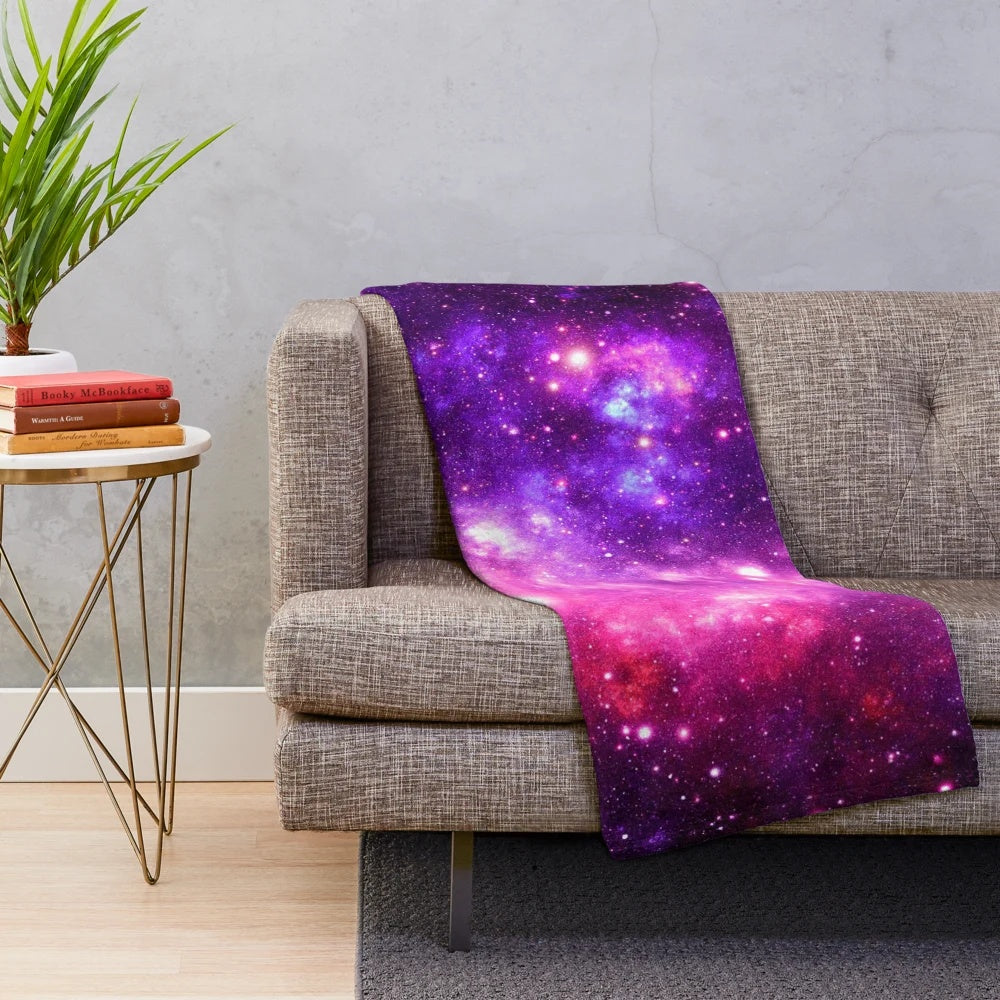 Soft and cozy pink and purple galaxy nebula plush blanket