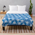 Geometric plush blanket with aperiodic Einstein tile patterns in shades of blue