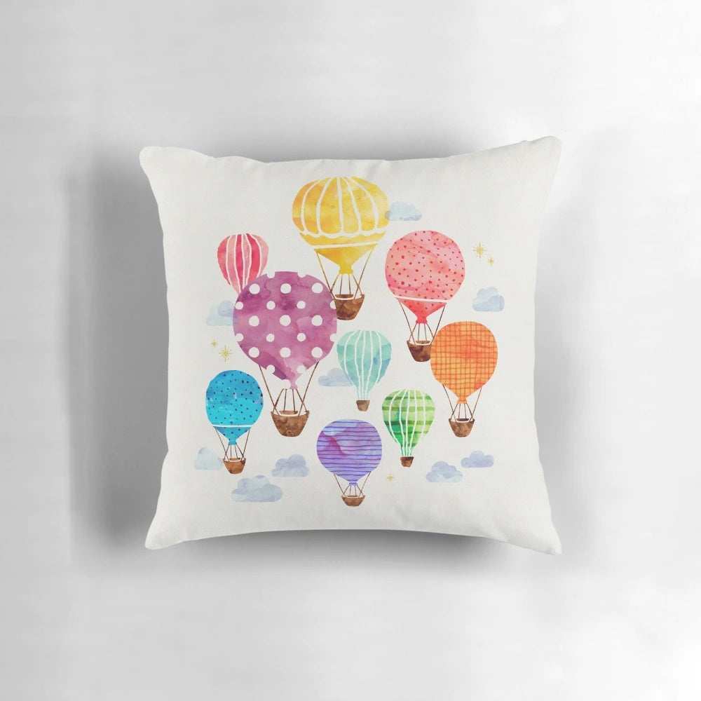 Vibrant hand-painted hot air balloon design on a plush, decorative pillow.