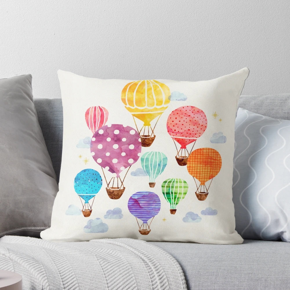 Vibrant hand-painted hot air balloon design on a plush, decorative pillow.