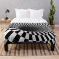 Black and white optical illusion plush blanket with a hypnotic checkered pattern