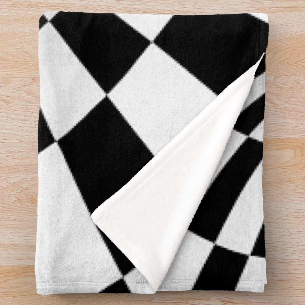 Black and white optical illusion plush blanket with a hypnotic checkered pattern