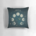 A decorative pillow featuring the different phases of the moon against a starry night sky background.