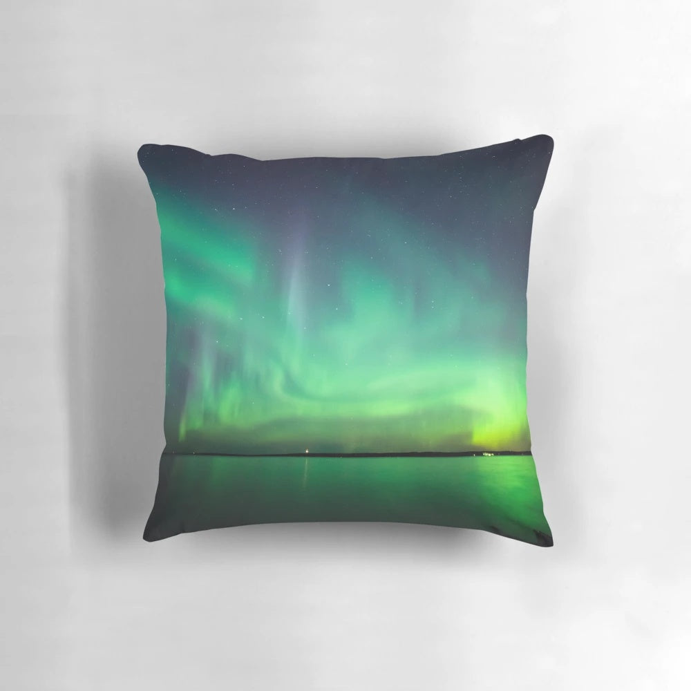 Stunning photograph of the northern lights reflecting on a tranquil lake, creating a breathtaking celestial display.