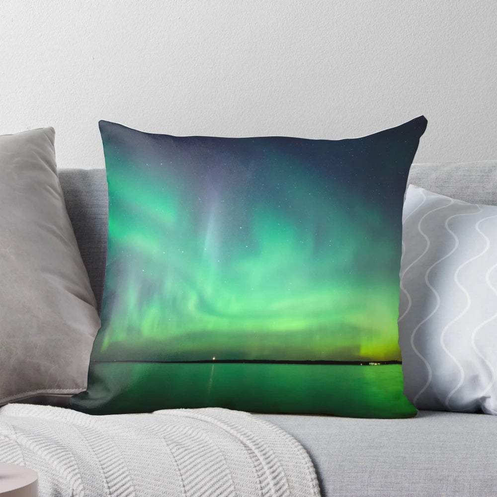 Stunning photograph of the northern lights reflecting on a tranquil lake, creating a breathtaking celestial display.