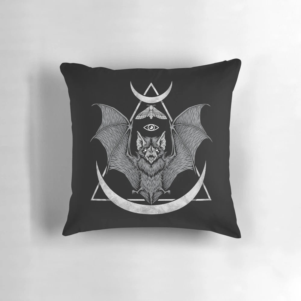 Black and white geometric bat pillow with moon and moth design