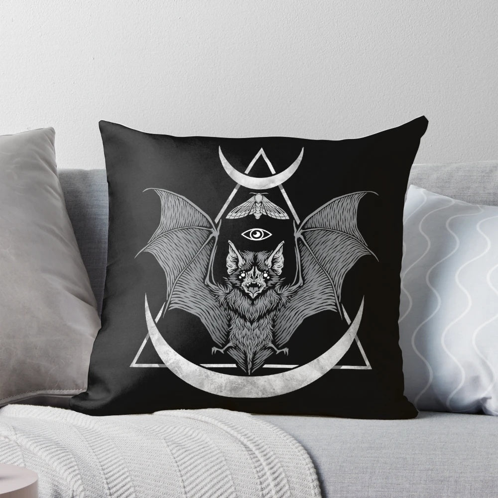 Black and white geometric bat pillow with moon and moth design