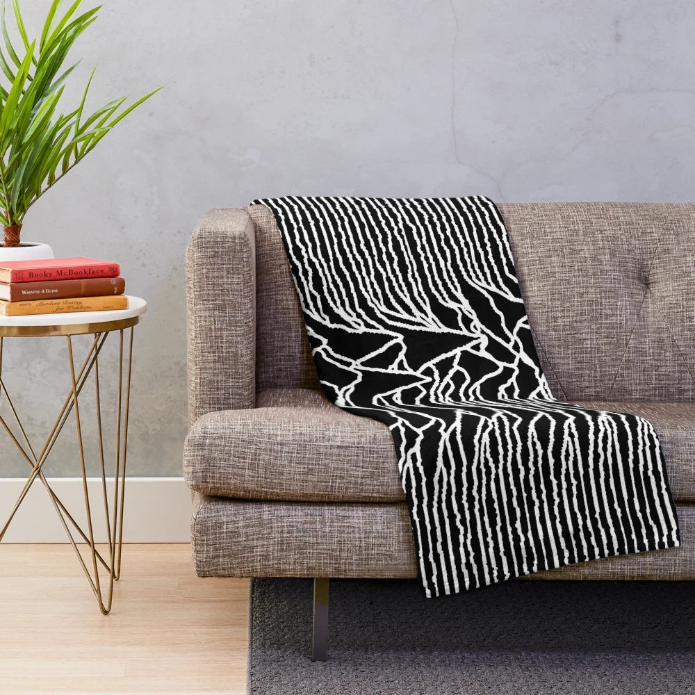 Plush blanket featuring the iconic "Unknown Pleasures" album cover design