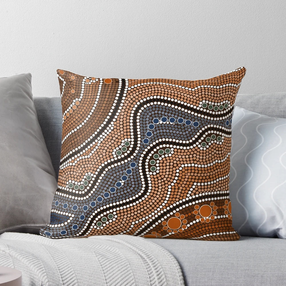 Decorative pillow with a mandala-inspired pattern of colorful points and blossoms