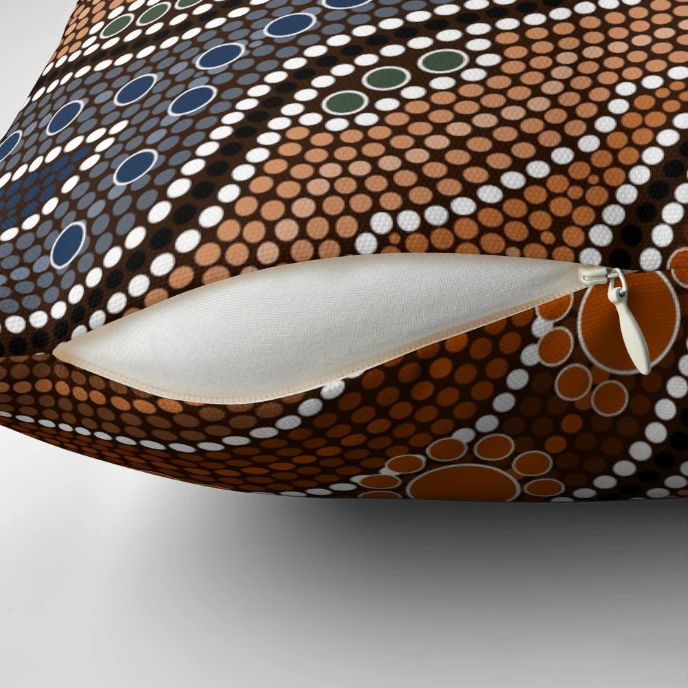 Decorative pillow with a mandala-inspired pattern of colorful points and blossoms