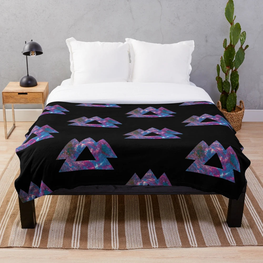 Trippy plush blanket with psychedelic, geometric, and galaxy-inspired design