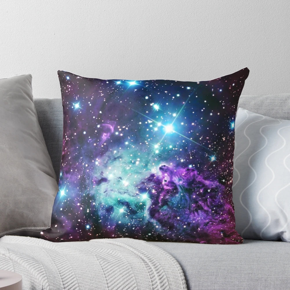 Turquoise, teal, and purple nebula-inspired pillow with a cosmic, galaxy-like design