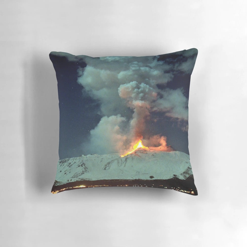 Pillow featuring a breathtaking image of a volcanic eruption at night, with lava fountains and a plume of smoke against a starry sky.